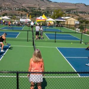 Pickle ball players on a sport court.